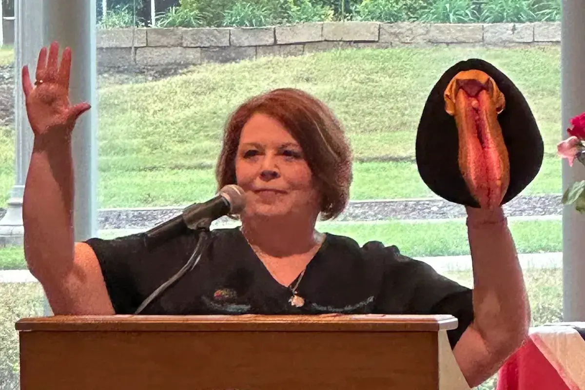 Traci speaking at a podium