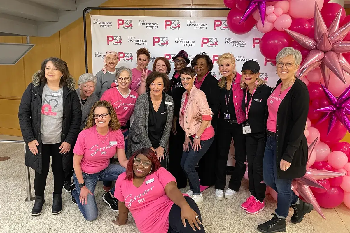Traci posing for a photo with the Project31 team
