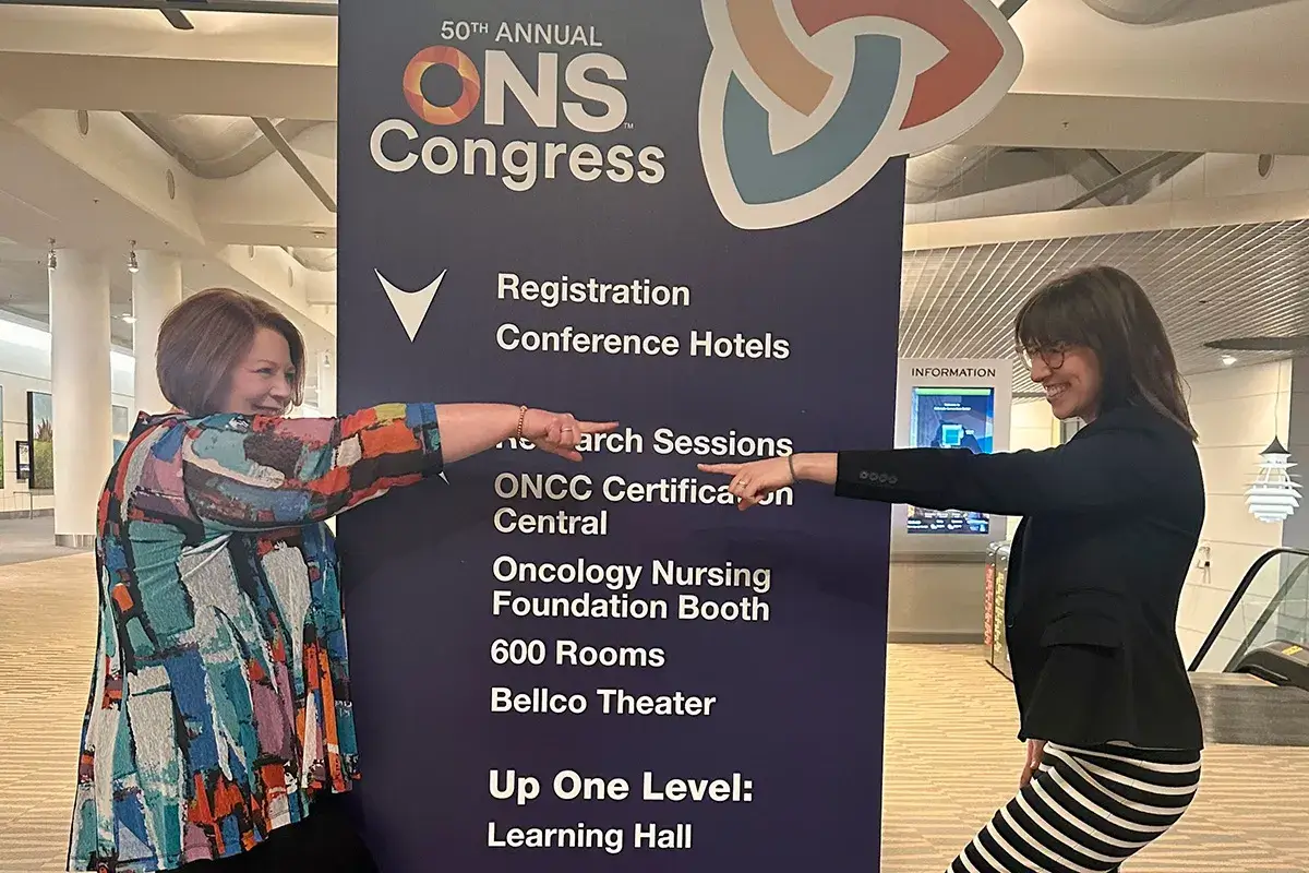 Traci and her colleague pointing to one another at ONS event