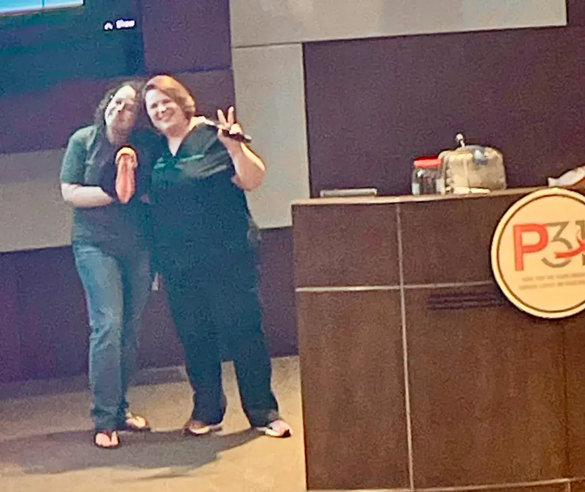Traci hugging a woman at her presentation