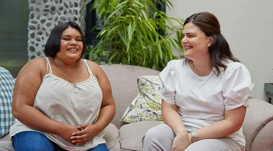 Two women sitting on couch