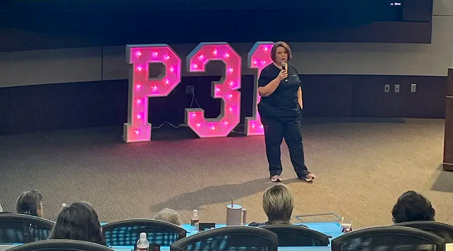 Traci speaking at event