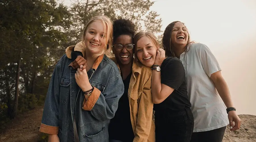 Woman standing and smiling together